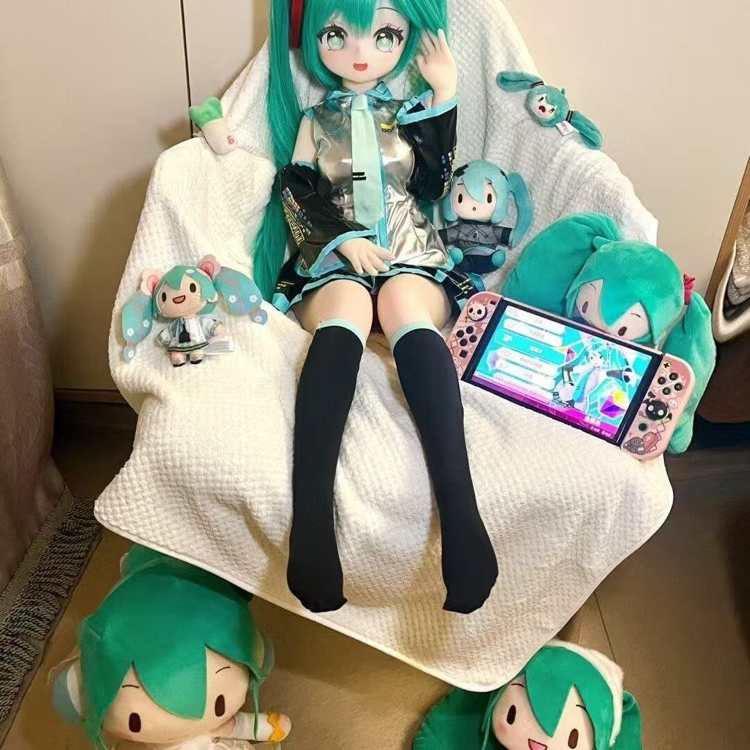 Miku 85cm Anime Inspired TPE Figure view 3 Miku 68cm Anime Inspired Tpe Figure Miku 85cm Anime Inspired Tpe Figure View 3 Dd036 Dd036 miku seated with gaming console and plush