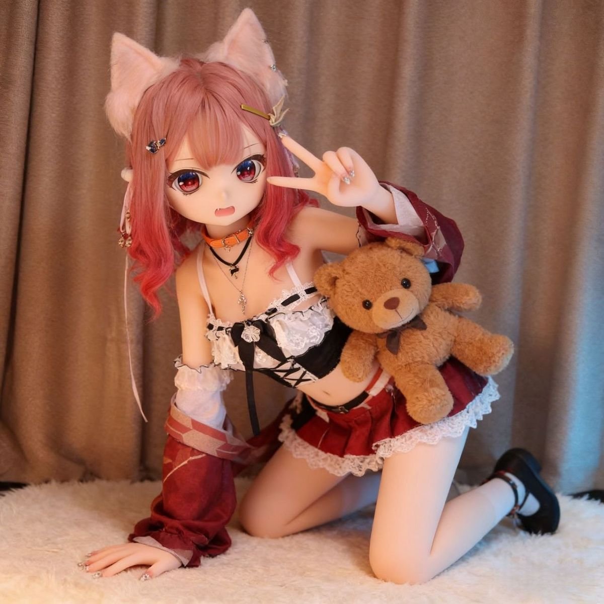 DD067 Momo 68cm TPE anime doll kneeling pose with a teddy bear showing playful personality Momo - 68cm Mini Anime TPE Doll with Articulated Skeleton, Realistic PVC Head, SKU: DD067 product image showing body appearance and material texture