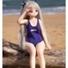DD073 Luna 68cm TPE anime doll sitting on a log, with a beach background, highlighting her elegant posture.