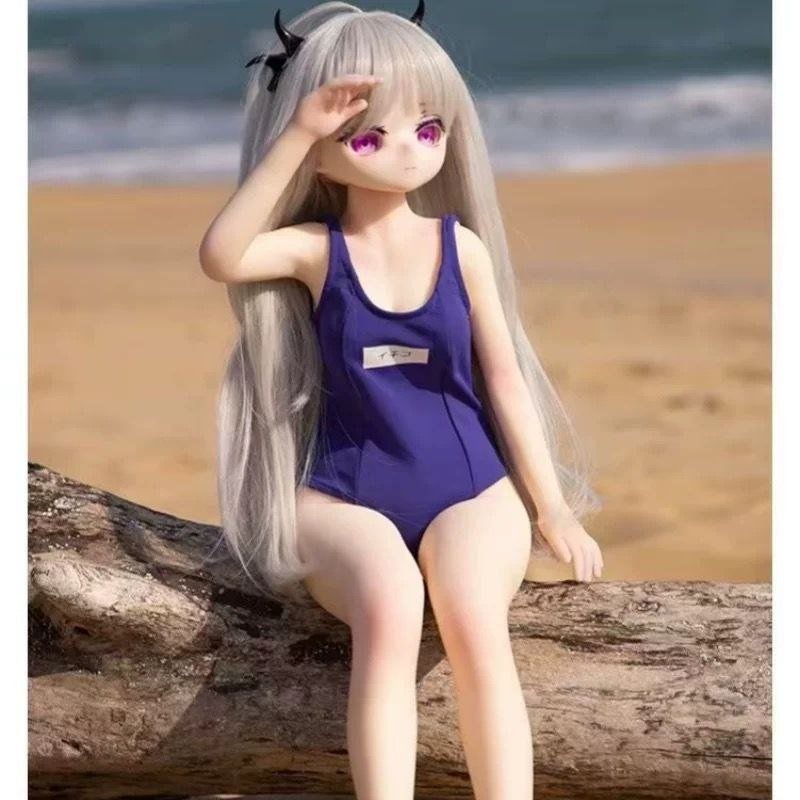 DD073 Luna 68cm TPE anime doll sitting on a log with a beach background highlighting her elegant posture Luna - 68cm Mini Anime Full-Body TPE Figure with Articulated Skeleton, TPE Body PVC Head, SKU: DD073 product image showing body appearance and material texture