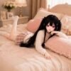 DD079 Yuki 85cm TPE anime doll, relaxed pose on a bed, highlighting her detailed facial features and articulated limbs.