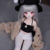DD081 Luna 85cm TPE realistic anime doll, seated pose showcasing her petite frame and stylish outfit.