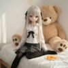 DD100 Yuki 68cm TPE anime doll seated on a bed with a teddy bear showcasing her full body and school uniform DD100 Yuki - Anime Full-Body TPE Figure with Articulated Skeleton 68cm product image showing body appearance and material texture