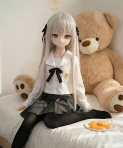 DD100 Yuki 68cm TPE anime doll, seated on a bed with a teddy bear, showcasing her full body and school uniform.