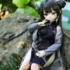 DD103 Mei 68cm TPE anime doll in a sitting pose on a rock, showcasing her outfit and legs.